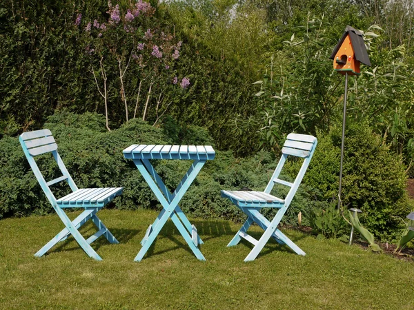 Blue outdoor garden furniture in green grass