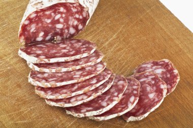 Salami with slices on wood clipart