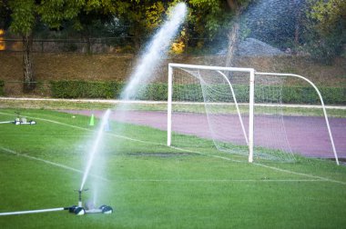 Watering in a football pitch clipart