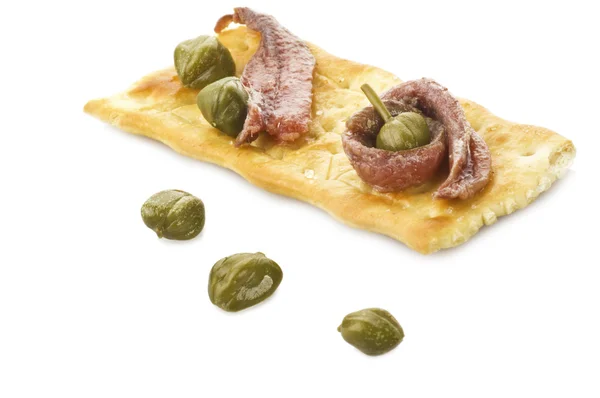 Anchovies and caper on the cracker — Stock Photo, Image