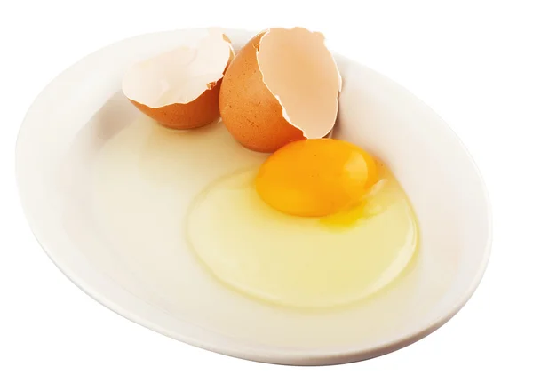 Stock image Raw egg tear into half with yolk and albumin