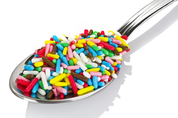 Colored candies on a spoon — Stock Photo, Image