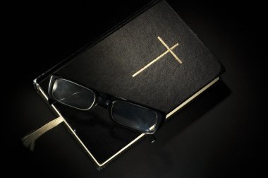 Bible with eyeglasses clipart