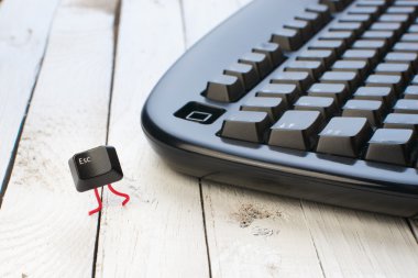 Escape key run away from a black keyboard clipart