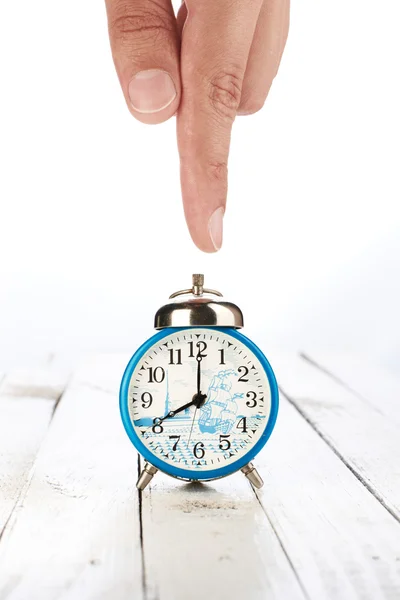 Alarm clock with hand — Stock Photo, Image