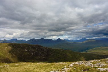 Scottish Highlands with dramatic sky clipart