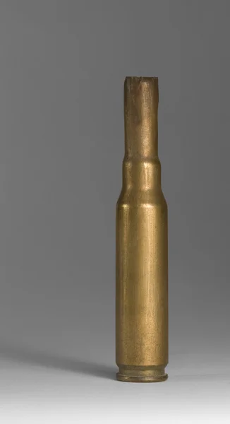 Metallic bullet casing in grey back — Stock Photo, Image