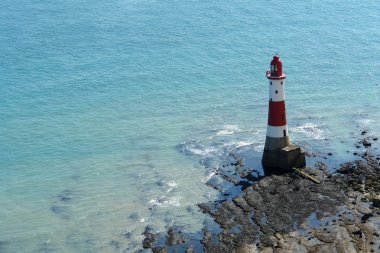 Lighthouse near Beachy Head at summer time clipart