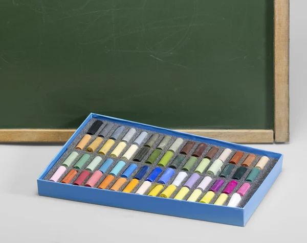Blackboard edge and crayons — Stock Photo, Image