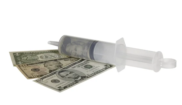 Plastic syringe and dollar banknotes — Stock Photo, Image