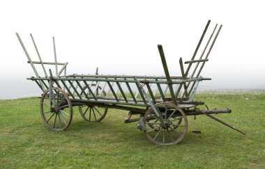Historic hayrack on a meadow clipart