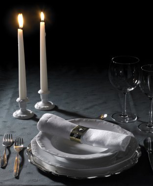 Festive place setting and candlelight clipart