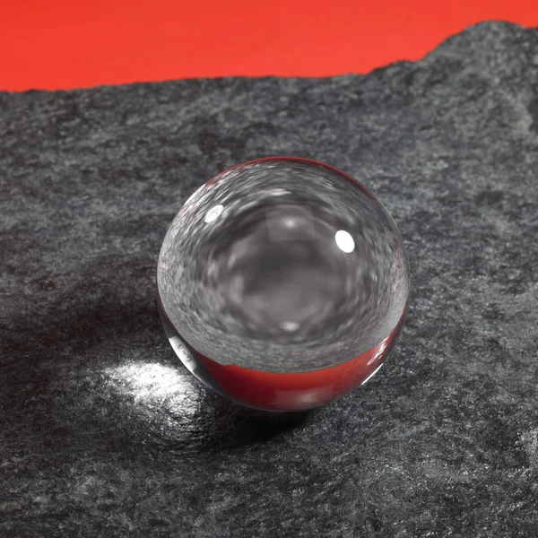 Crystal ball on stone surface — Stock Photo, Image