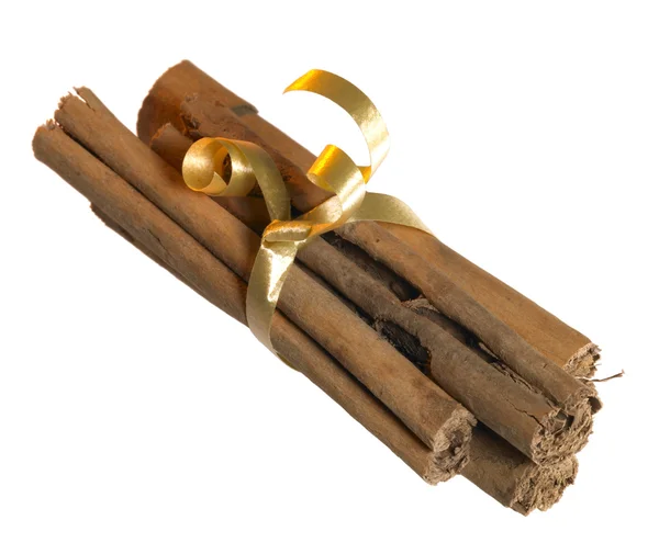 Cinnamon sticks with golden bow — Stock Photo, Image
