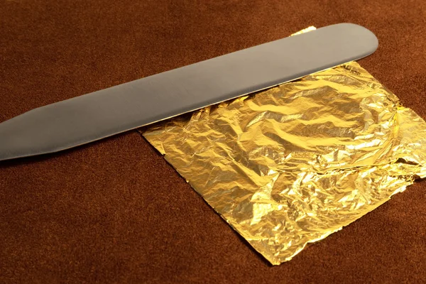 Gold leaf and blade — Stock Photo, Image