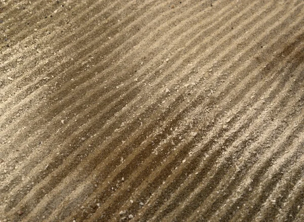 Borrade linjer i brun sand ytan — Stockfoto