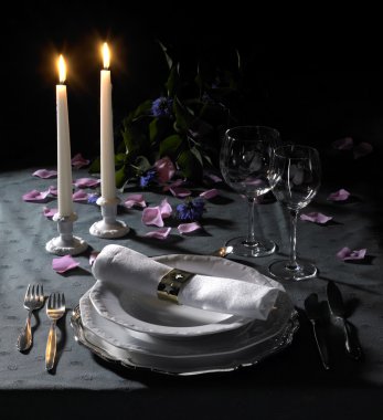 Festive place setting and candlelight clipart