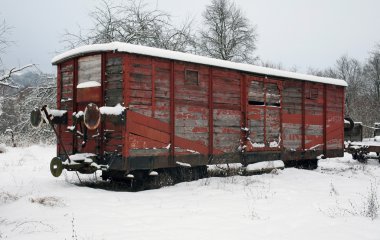 Old railway car at winter time clipart
