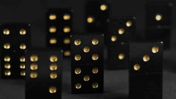 Black dominoes with golden spots — Stock Photo, Image
