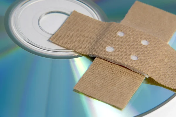 Adhesive plaster and CD ROM detail — Stock Photo, Image