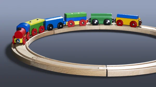 Colorful wooden toy train on tracks — Stock Photo, Image