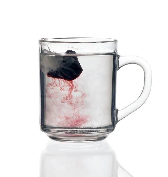 Glass teacup with tea bag — Stock Photo, Image