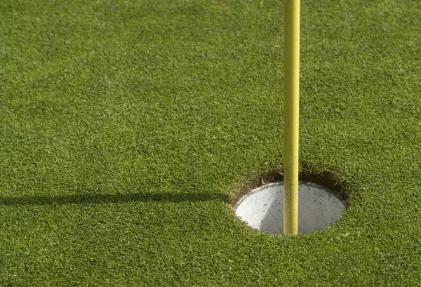 Golf agujero y pila en el interior —  Fotos de Stock