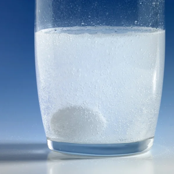 Фізична таблетка в склянці води — стокове фото