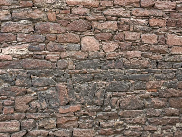 Načervenalé kamenná zeď — Stock fotografie
