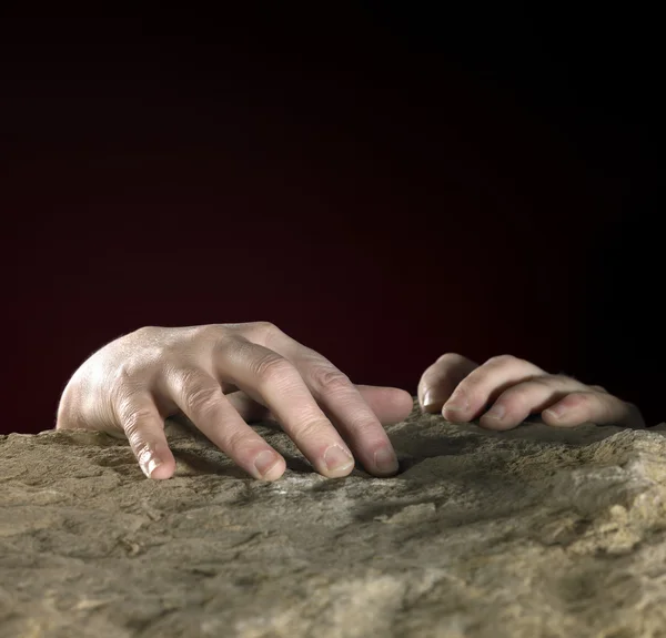 Hands on stone surface — Stock Photo, Image