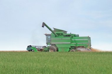 Harvesting harvester on a crop field clipart