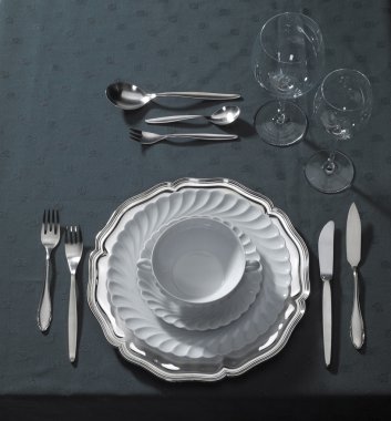 Noble place setting on dark tablecloth clipart