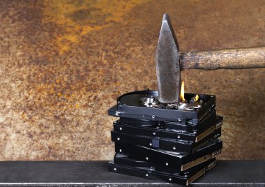 Hammer and burning hard disks clipart