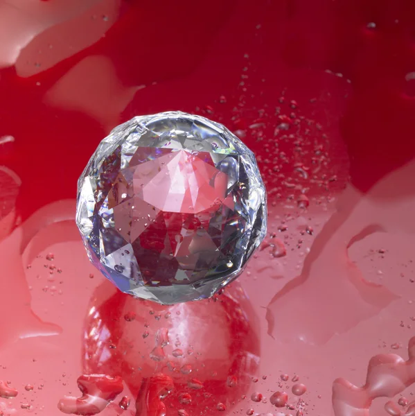 Diamond sphere in red wet ambiance — Stock Photo, Image