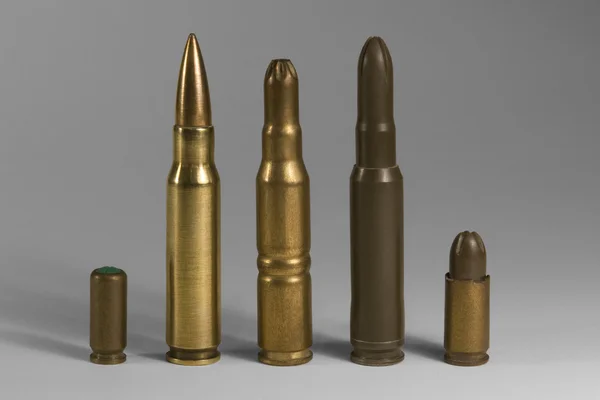Various upright ammunition in grey back — Stock Photo, Image