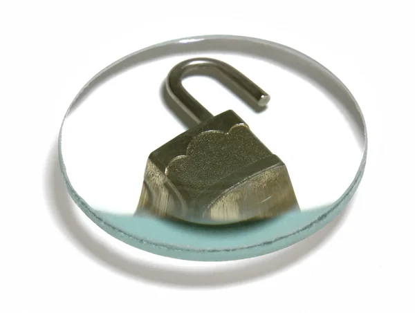 Open padlock under glass lens — Stockfoto