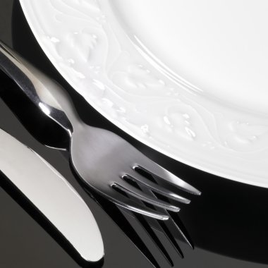 Porcelain dinnerware with fork and knife clipart