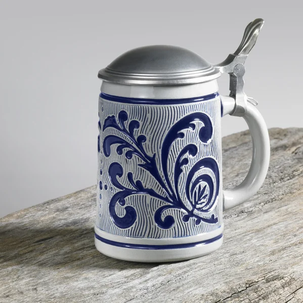 Blue decorated stein on wooden surface — Stock Photo, Image