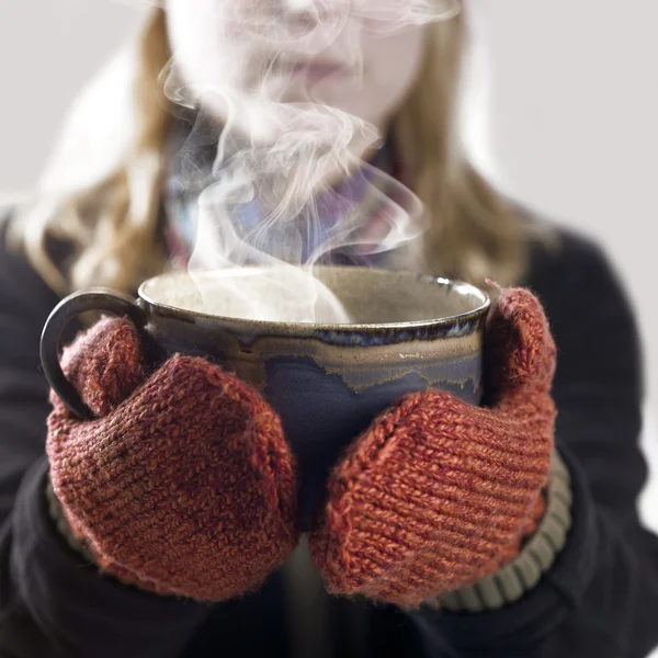Woman and hot steaming cup — Stock Photo, Image
