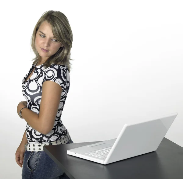 Young cute girl turns away from laptop — Stock Photo, Image