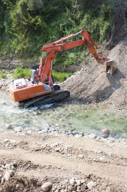 Excavator in the river clipart