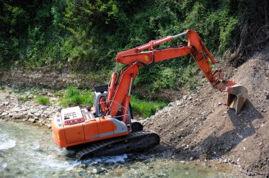 Excavator in the river clipart