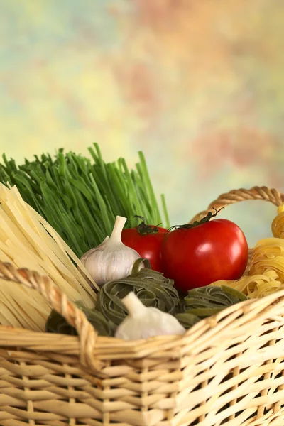 Raw Tagliatelle in Basket with Tomato and Garlic