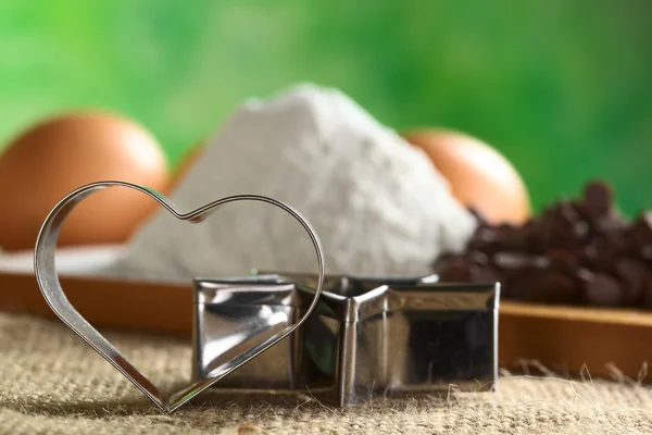 Stock image Heart-Shaped Cookie Cutter with Baking Ingredients