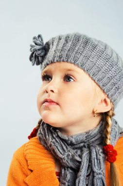 Llittle girl in warm clothes clipart