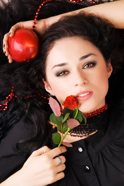 Schöne romantische Frau mit einem roten Apfel und einer Rose — Stockfoto