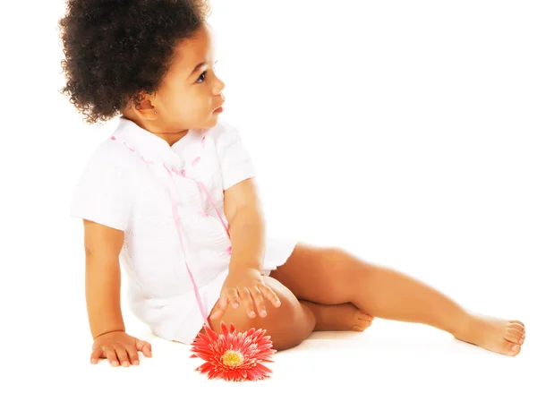 Pretty little girl reaching for flower — Stock Photo, Image