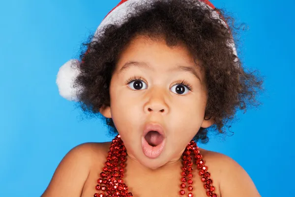 Surprised little child in Christmas hat — Stock Photo, Image