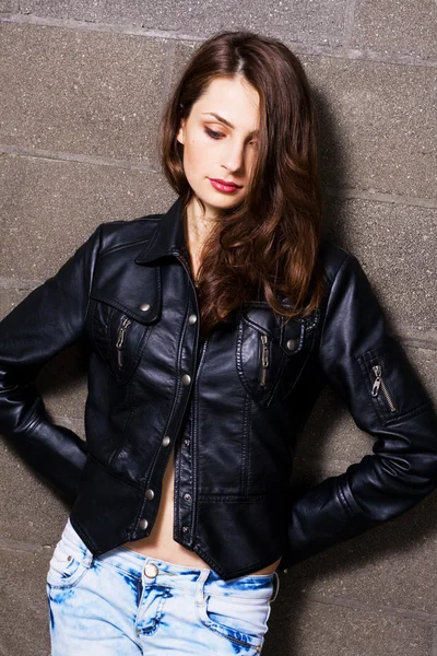 Pretty young woman in a leather black jacket — Stock Photo, Image