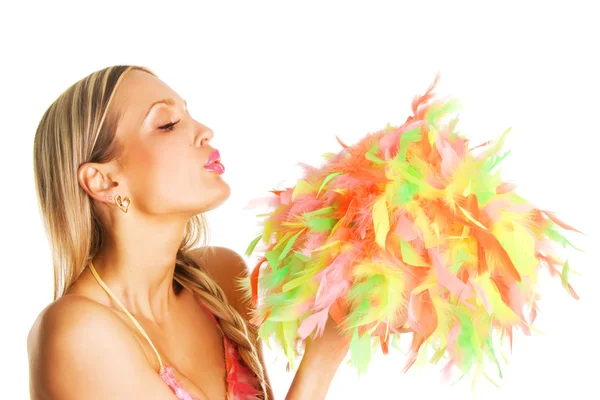 Pretty girl blowing on colorful feathers — Stock Photo, Image